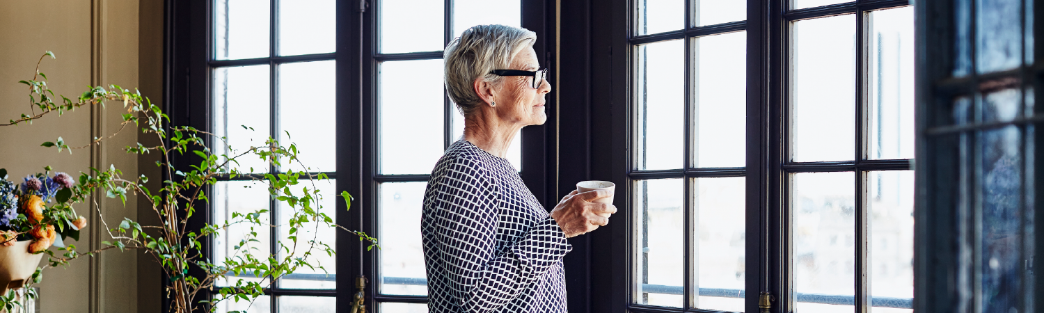 Woman contemplating, looking out the window
